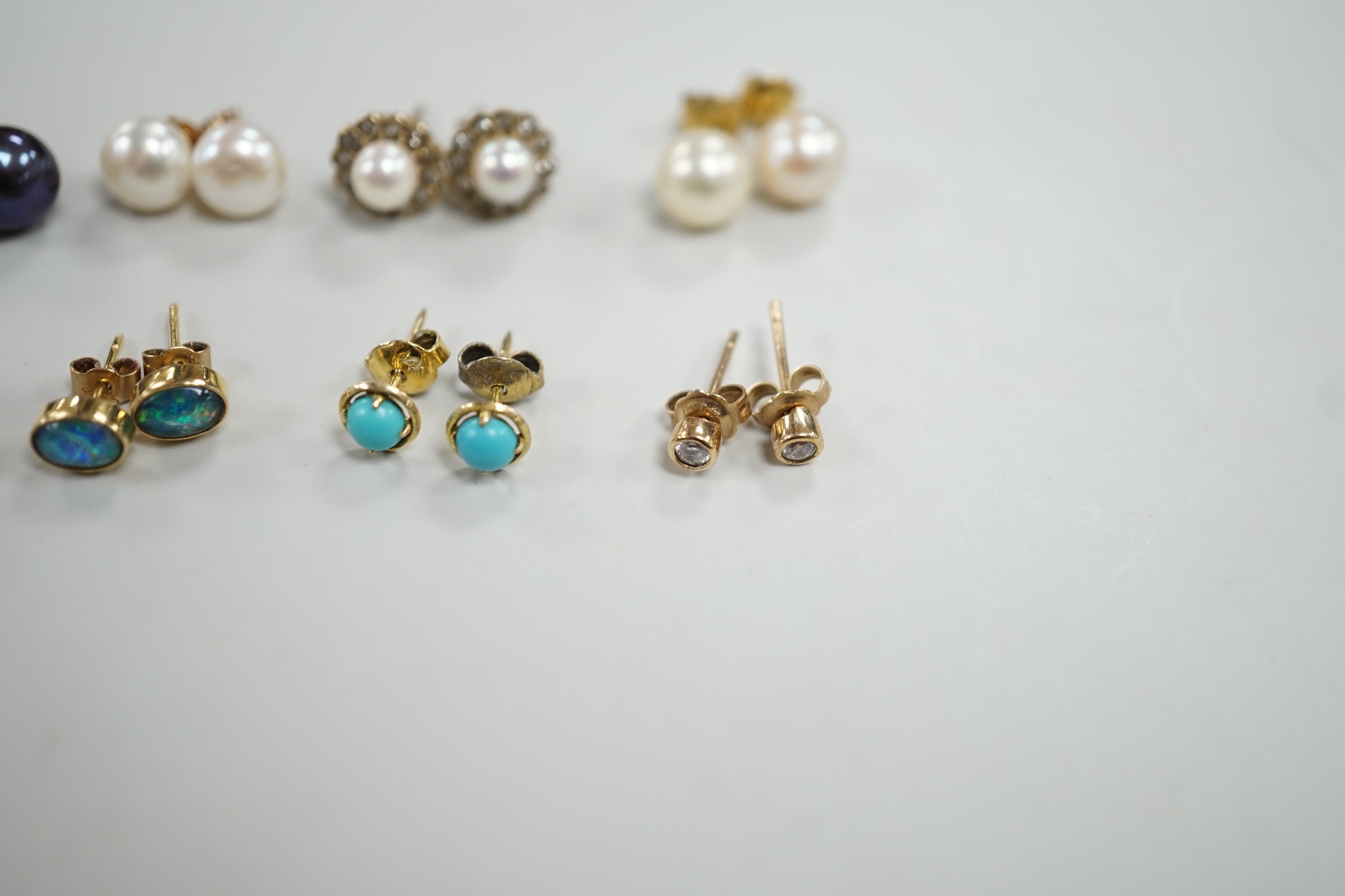 Eight assorted modern pairs of ear studs, including a 14k and cultured pearl and two other cultured pearl, one 9ct and diamond chip.